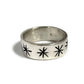 Wide band ring with carved asterix stars in silver.