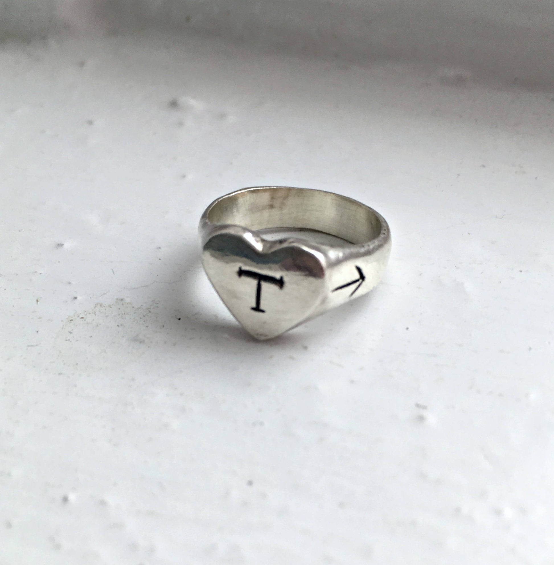 silver heart-shaped signet ring with engraved initial