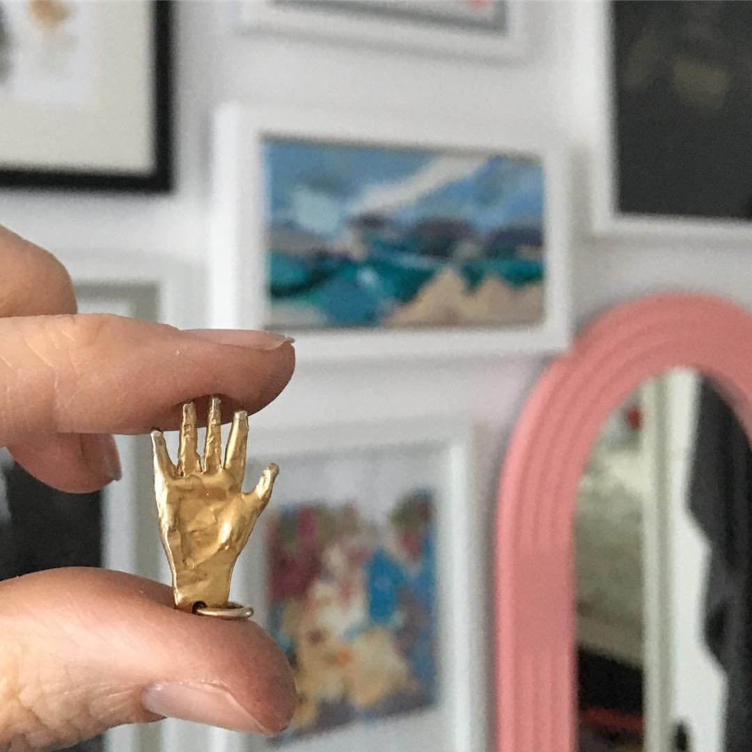 hand shaped silver body part  pendant in gold