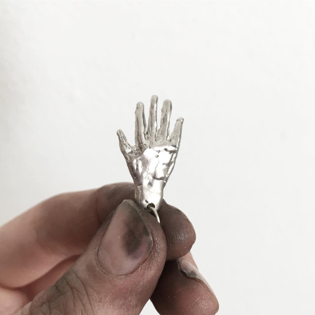 Hand shaped pendant made from solid silver 