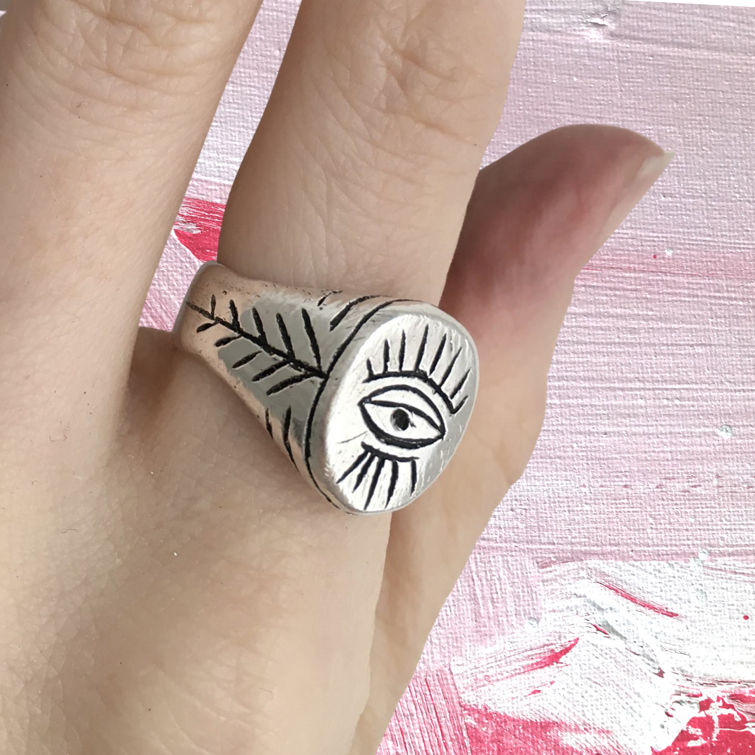 Chunky oval signet ring with evil eye motif