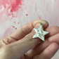 large sterling silver star pendant with a face