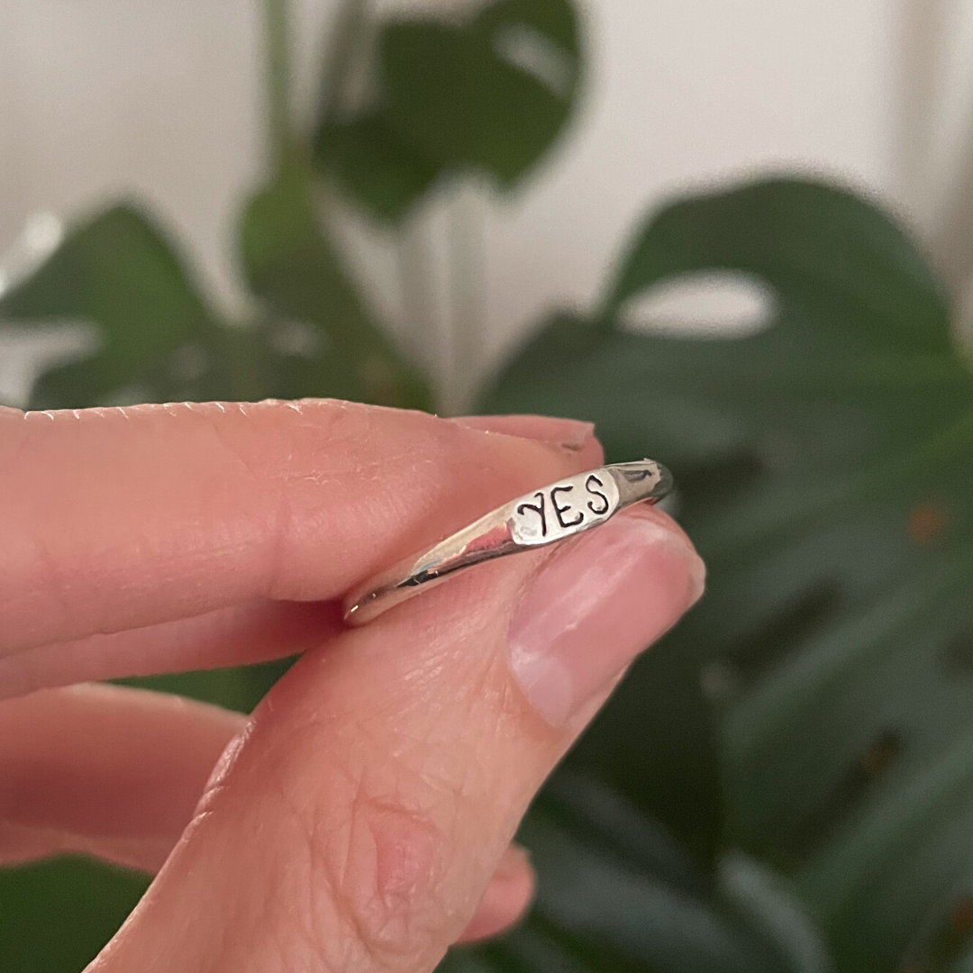 delicate silver band ring with engraved yes